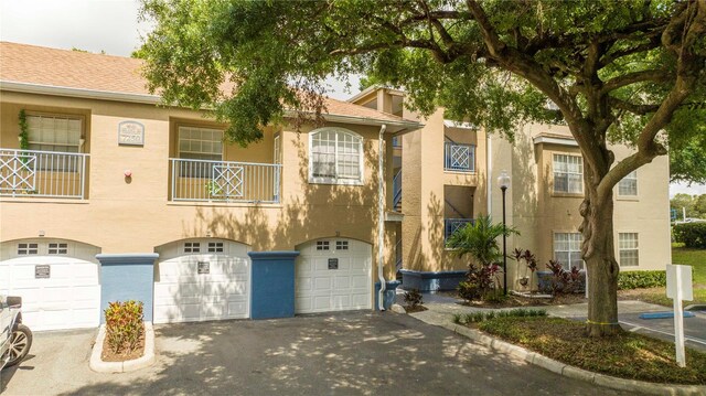 townhome / multi-family property with a garage and a balcony