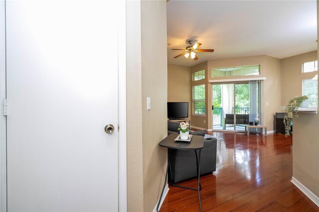 living room with wood-type flooring and ceiling fan