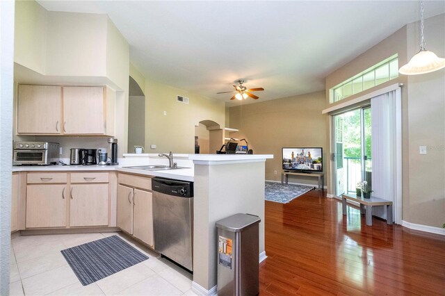 kitchen featuring light hardwood / wood-style floors, kitchen peninsula, dishwasher, light brown cabinetry, and sink