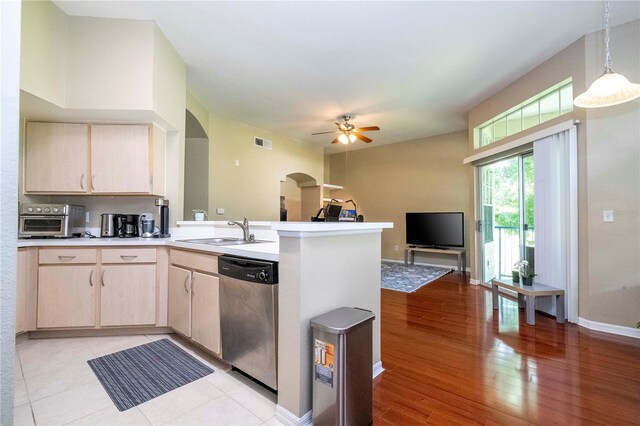 kitchen featuring light brown cabinets, sink, dishwasher, and kitchen peninsula