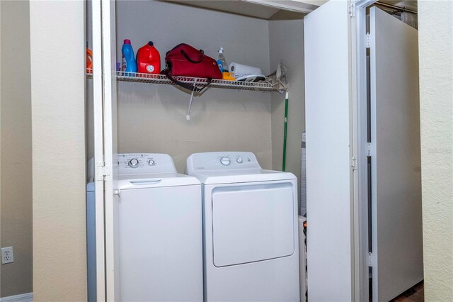 laundry area with washing machine and clothes dryer