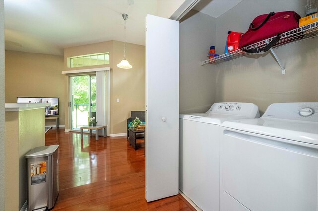 laundry room with wood-type flooring and independent washer and dryer