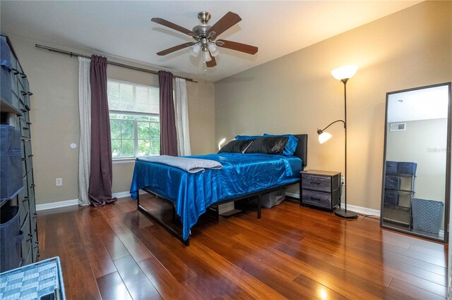 bedroom with ceiling fan and dark hardwood / wood-style floors