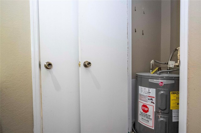 utility room featuring water heater