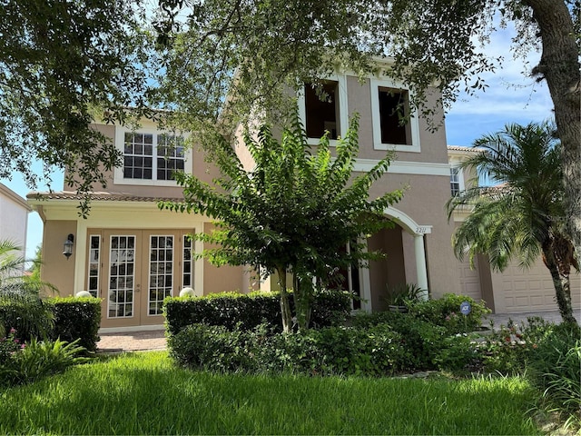 view of front of home with stucco siding and french doors