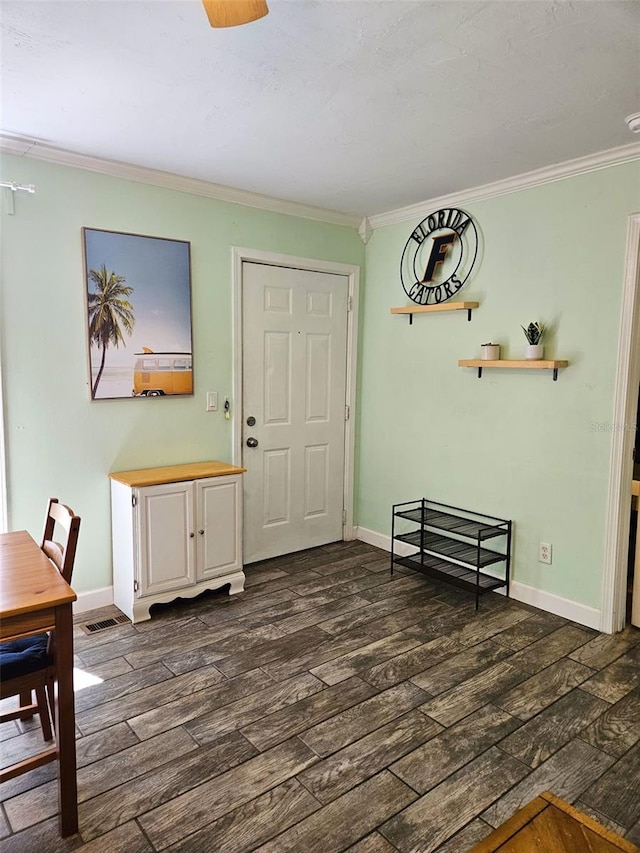 dining room with dark hardwood / wood-style flooring and ornamental molding