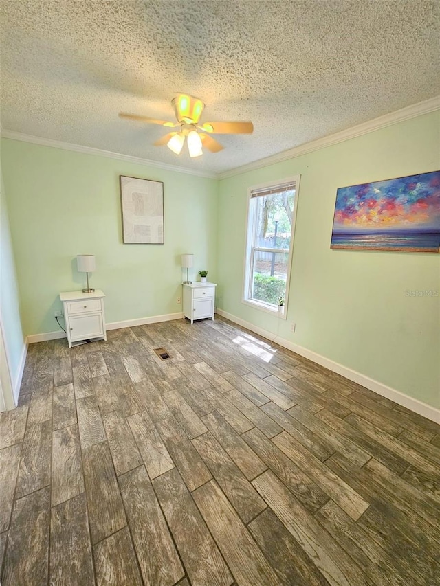 interior space with ceiling fan, hardwood / wood-style floors, a textured ceiling, and ornamental molding