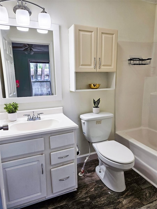 full bathroom featuring ceiling fan, shower / washtub combination, vanity, and toilet