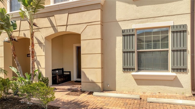 property entrance with stucco siding