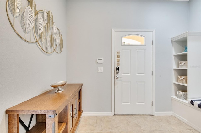 entrance foyer featuring light tile patterned flooring and baseboards