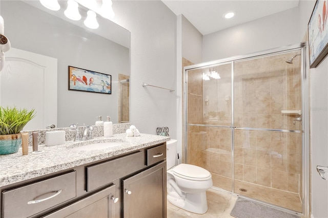 bathroom with an enclosed shower, tile flooring, vanity, and toilet