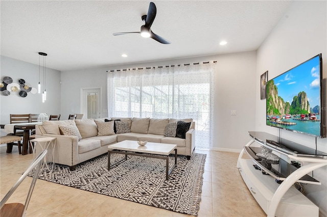 tiled living room featuring ceiling fan and a textured ceiling