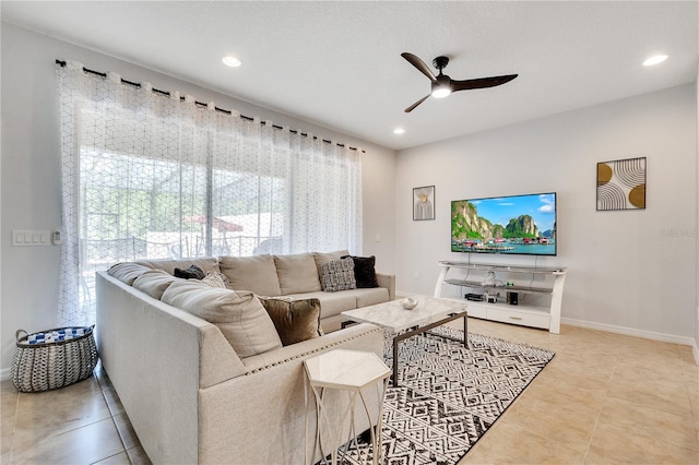 living room featuring ceiling fan and light tile floors