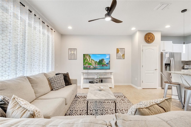 living area with baseboards, visible vents, ceiling fan, and recessed lighting