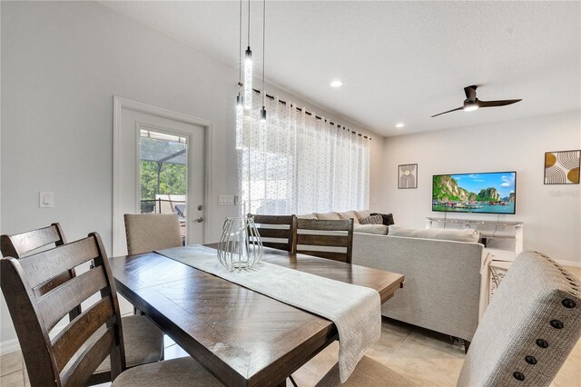 dining space featuring light tile flooring and ceiling fan