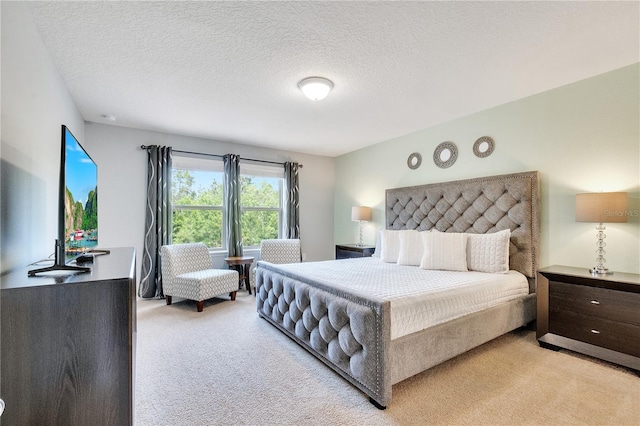 carpeted bedroom featuring a textured ceiling