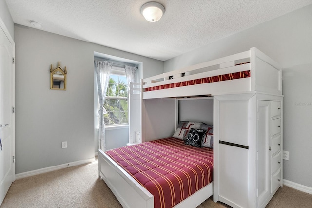 carpeted bedroom featuring a textured ceiling