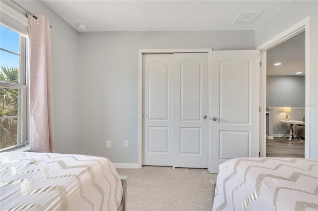 bedroom with a closet and light hardwood / wood-style flooring