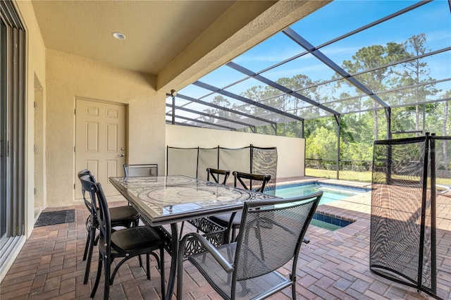 view of patio with glass enclosure, outdoor dining space, and an outdoor pool