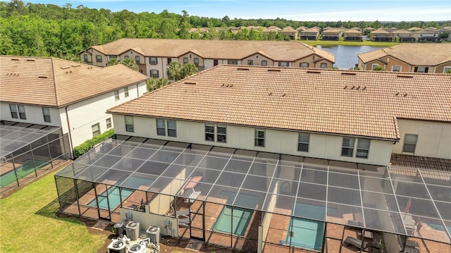 birds eye view of property with a water view and a residential view