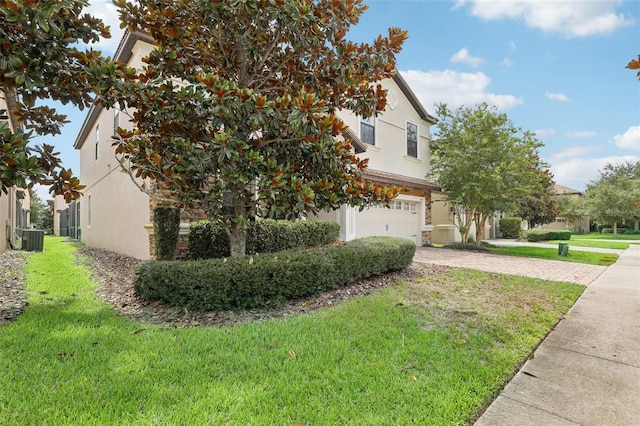 view of property exterior featuring a garage, central AC, and a lawn