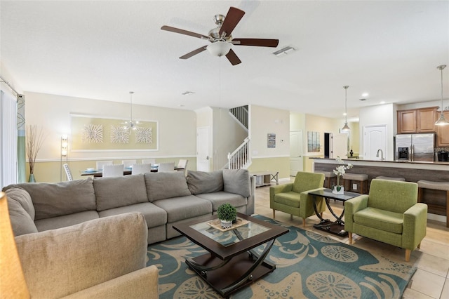 tiled living room featuring ceiling fan and sink