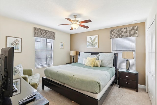 carpeted bedroom featuring a closet and ceiling fan