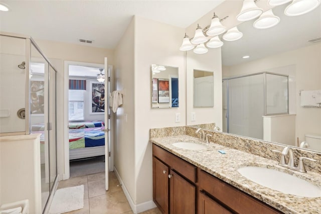 bathroom with toilet, ceiling fan, tile patterned flooring, walk in shower, and vanity