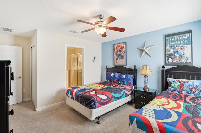 bedroom with ceiling fan, ensuite bath, light carpet, and a closet