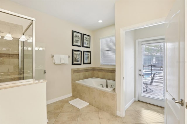 bathroom with tile patterned flooring and separate shower and tub