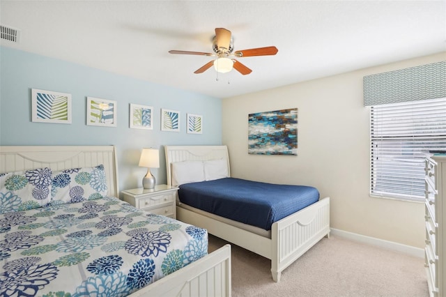 bedroom with ceiling fan and light colored carpet