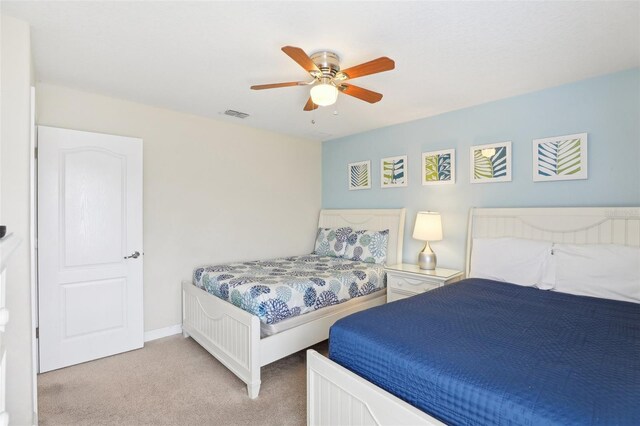 bedroom with ceiling fan and light carpet