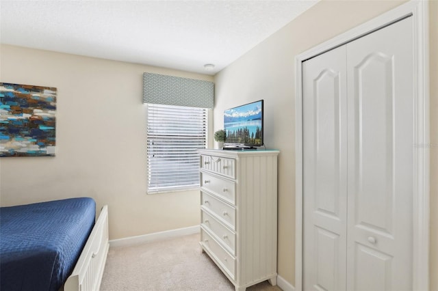 carpeted bedroom featuring a closet