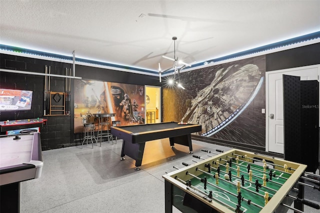 recreation room with a textured ceiling and billiards