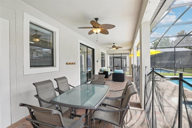 sunroom / solarium featuring ceiling fan