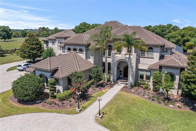 mediterranean / spanish-style home with a front lawn