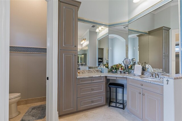 bathroom featuring tile patterned floors, vanity, toilet, and ornamental molding