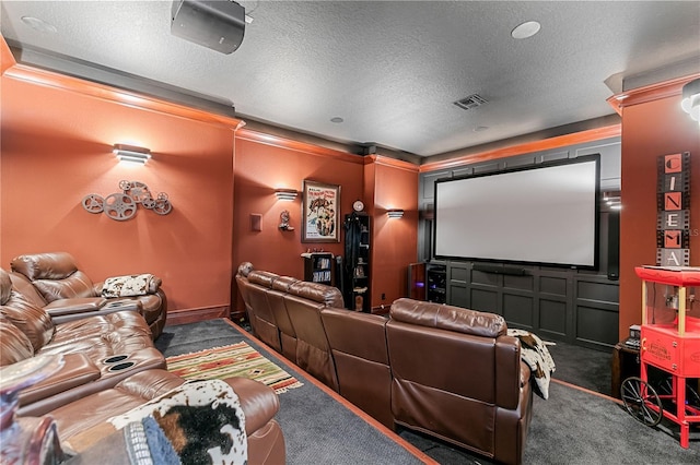 carpeted cinema featuring ornamental molding and a textured ceiling