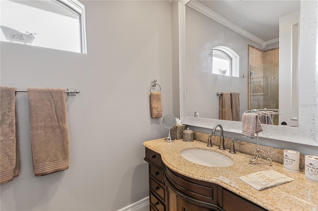 bathroom with vanity, an enclosed shower, and ornamental molding