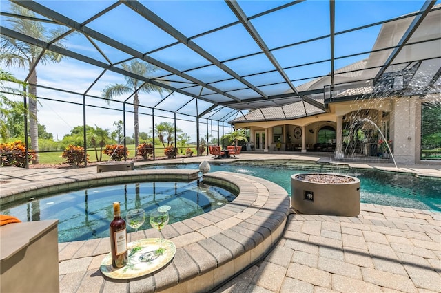 view of swimming pool featuring an in ground hot tub, pool water feature, a patio area, and a lanai