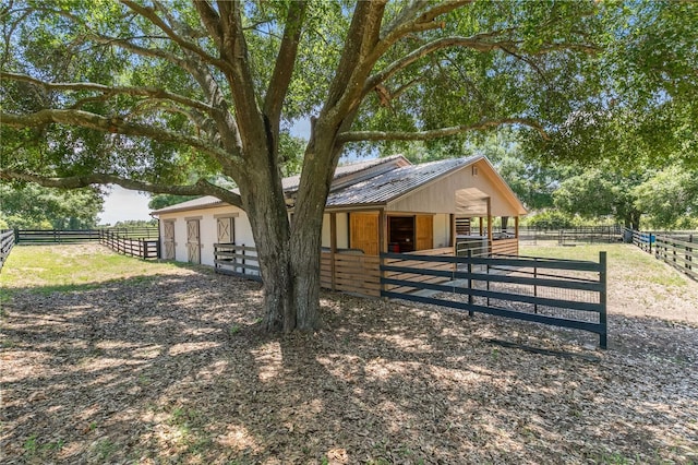 exterior space featuring an outbuilding and a rural view