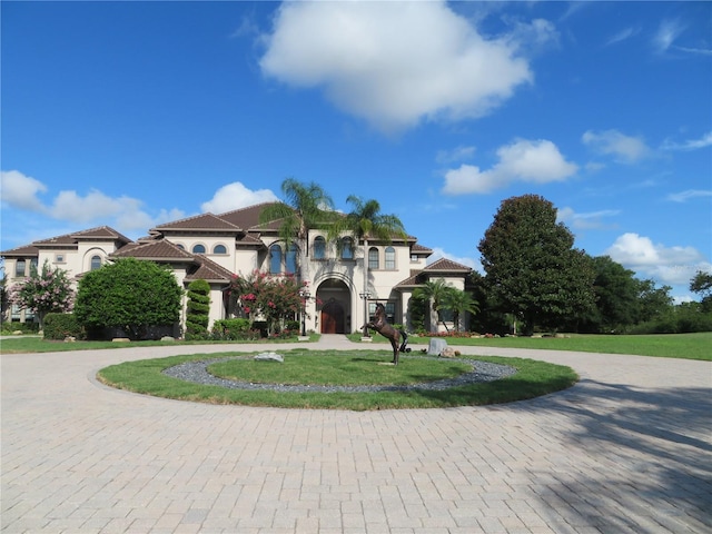 mediterranean / spanish-style house with a front yard