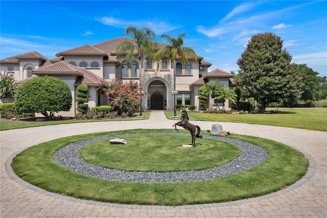 mediterranean / spanish-style home with a front yard