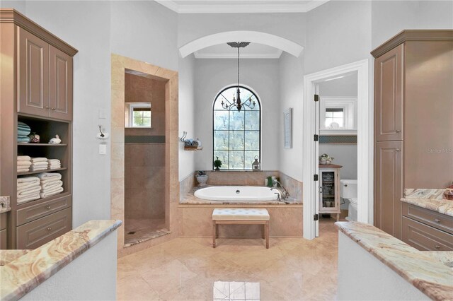 full bathroom with ornamental molding, vanity, separate shower and tub, an inviting chandelier, and toilet