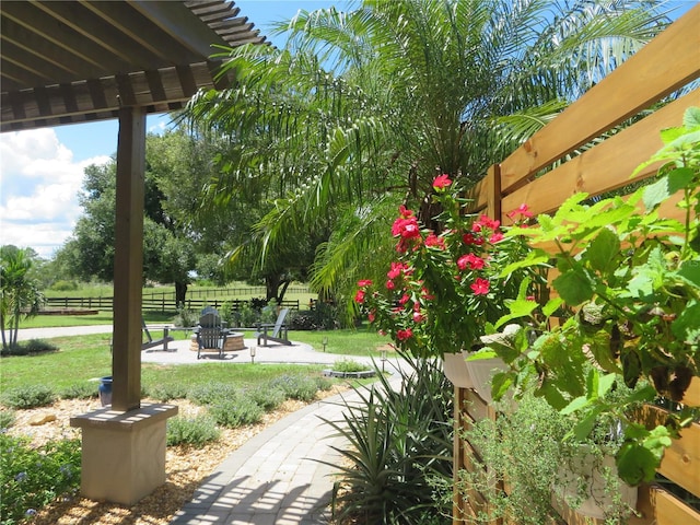 exterior space featuring a yard, a patio, and an outdoor fire pit