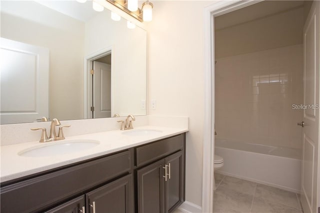 full bathroom with tile patterned floors, vanity, toilet, and  shower combination