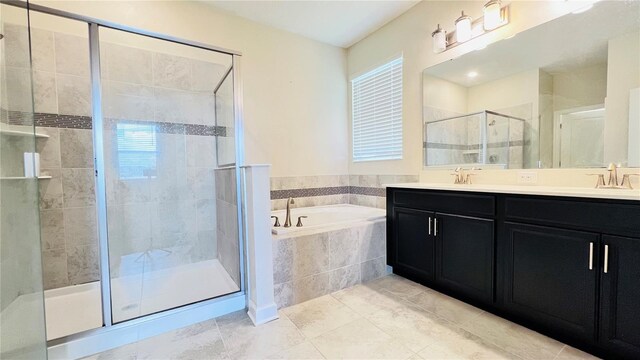 bathroom featuring tile patterned flooring, vanity, and shower with separate bathtub