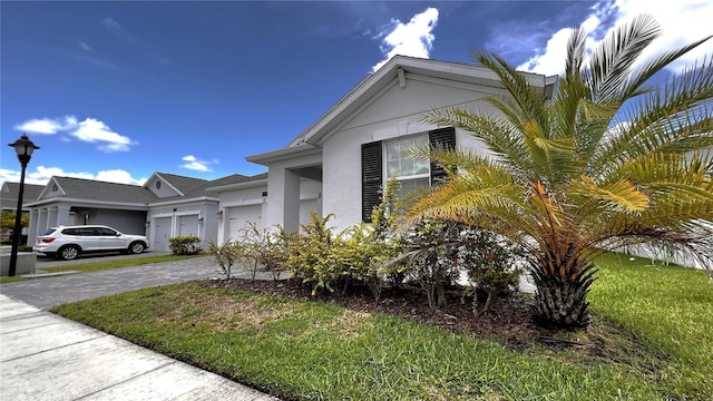 view of property exterior with a yard and a garage