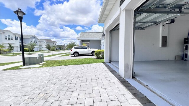 view of patio featuring hybrid water heater and electric panel