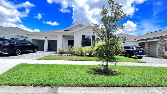 view of front of property with a front lawn and a garage